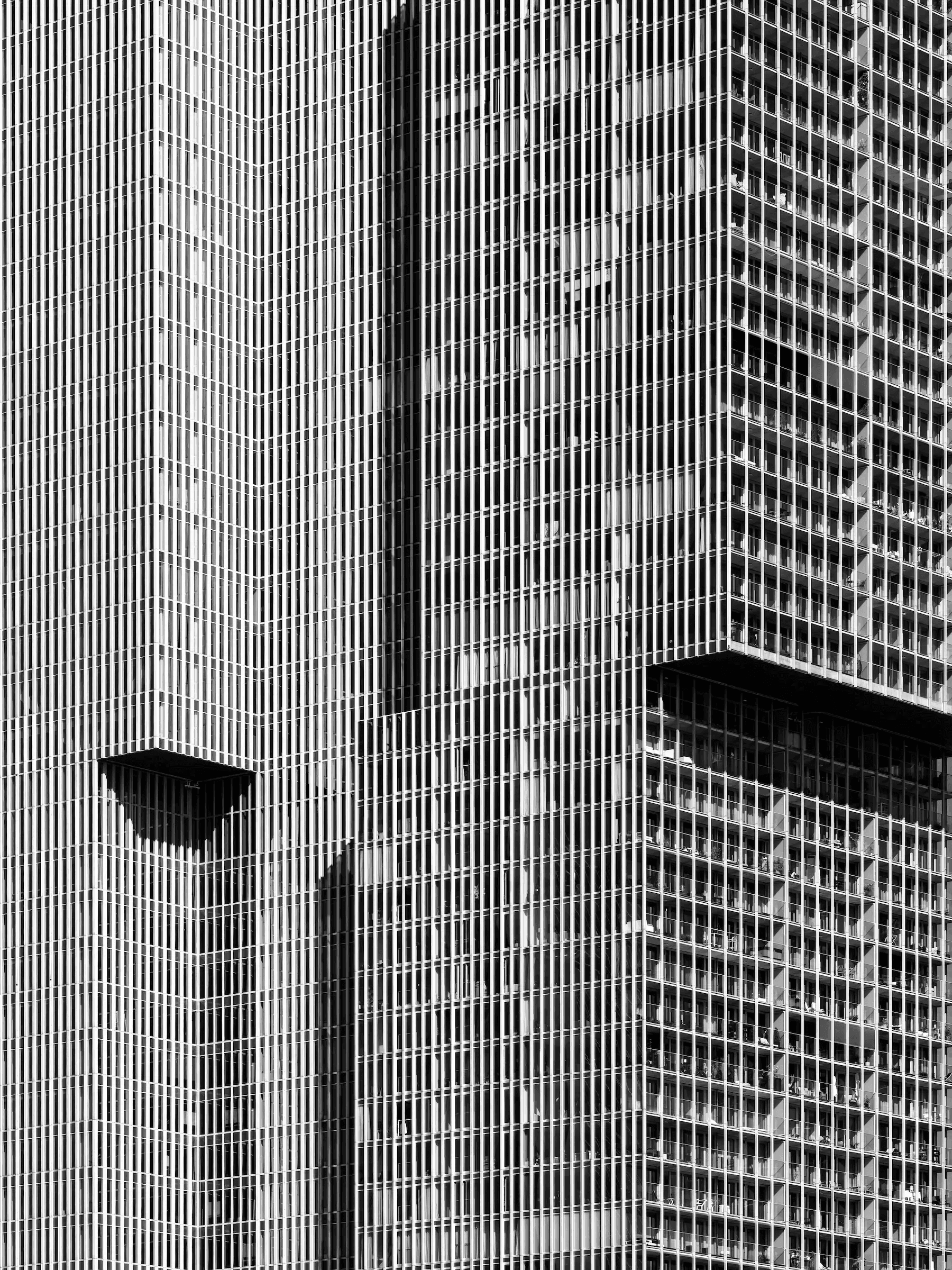 Vertical City: Rhythms of De Rotterdam Abstract black and white photograph of the facade of the 'De Rotterdam' building.